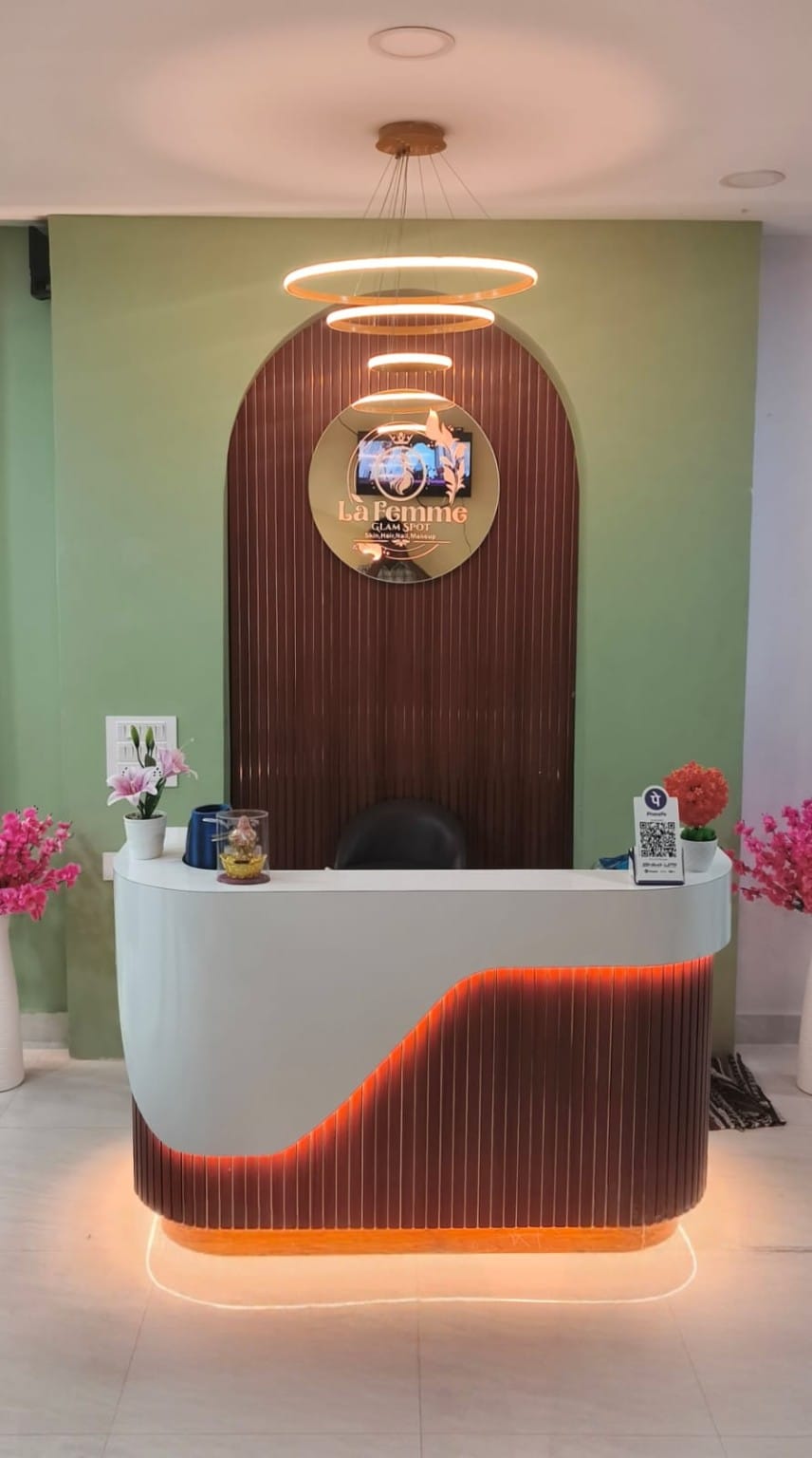 Reception desk with arched wood panel and ring pendant lights